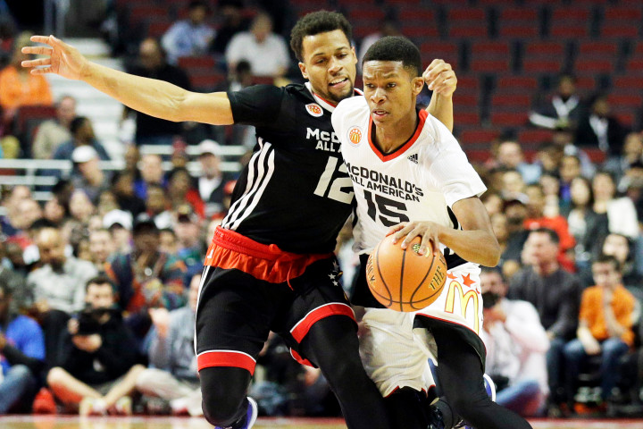 West pint guard PJ Dozier, right, of Spring Valley high school, in Columbia, S.C., drives against East point guard Isaiah Briscoe of Roselle Catholic high school in Roselle, N.J., during the first half of the McDonald's All-American boys basketball game in Chicago on Wednesday, April 1, 2015. (AP Photo/Nam Y. Huh)