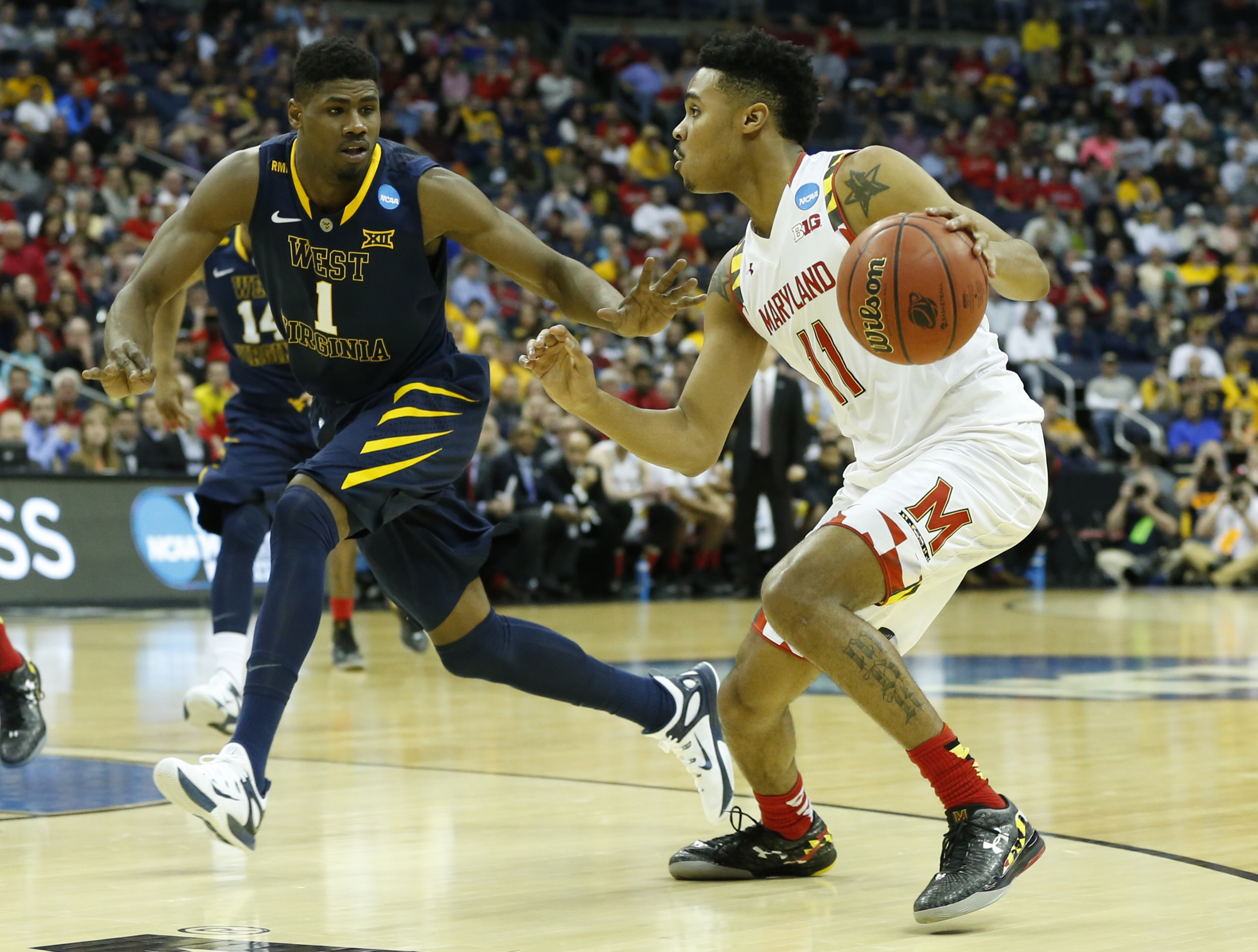 Mar 22, 2015; Columbus, OH, USA; Maryland Terrapins guard/forward Jared Nickens (11) dribbles while guarded by West Virginia Mountaineers forward Jonathan Holton (1) during the first half in the third round of the 2015 NCAA Tournament at Nationwide Arena. Mandatory Credit: Greg Bartram-USA TODAY Sports
