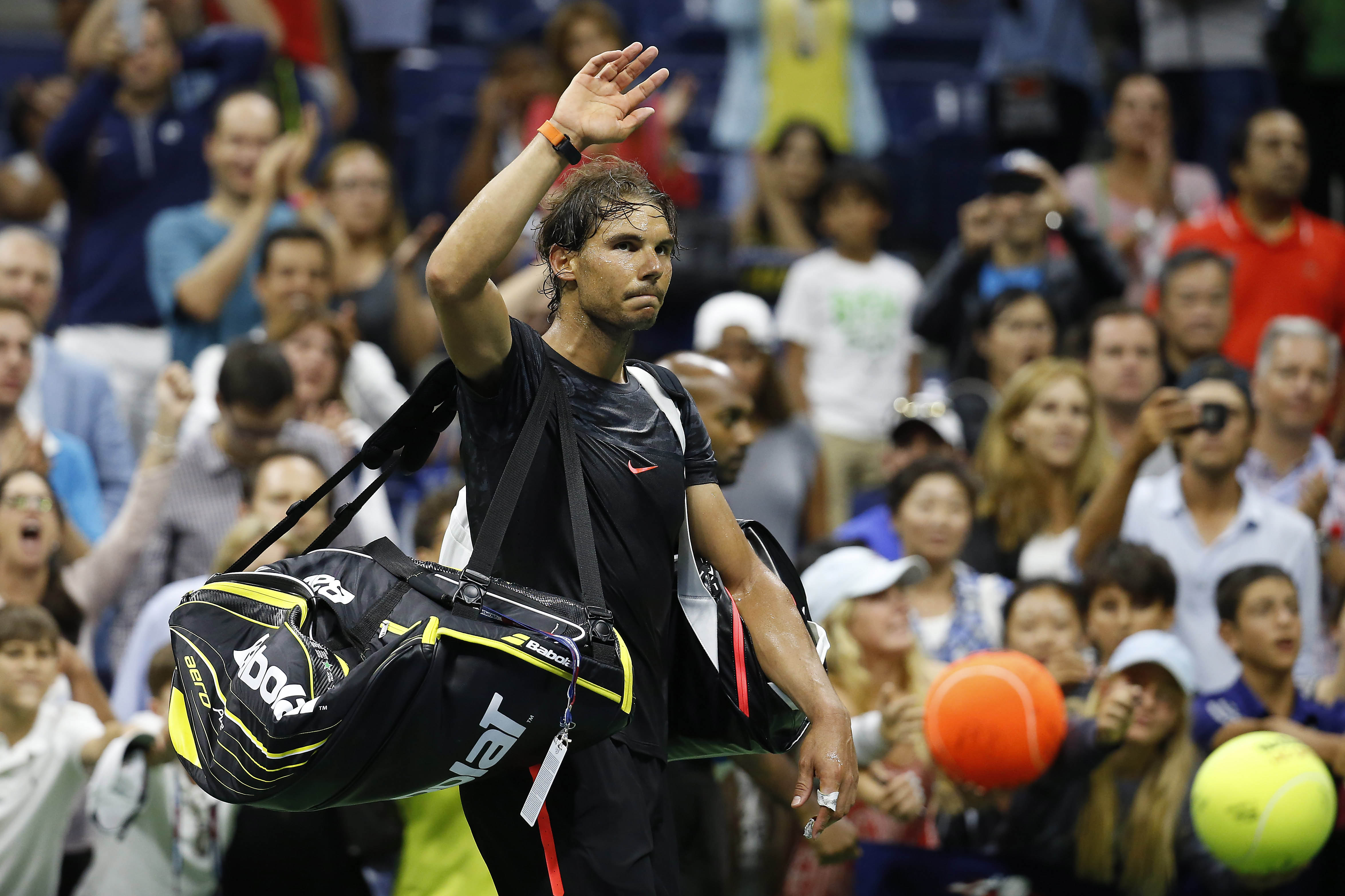 Sep 4, 2015; New York, NY, USA; Rafael Nadal of Spain waves to the crowd as he leaves the court after his match against Fabio Fognini of Italy (not pictured) on day five of the 2015 U.S. Open tennis tournament at USTA Billie Jean King National Tennis Center. Fognini won 3-6, 4-6, 6-4, 6-3, 6-4. Mandatory Credit: Geoff Burke-USA TODAY Sports