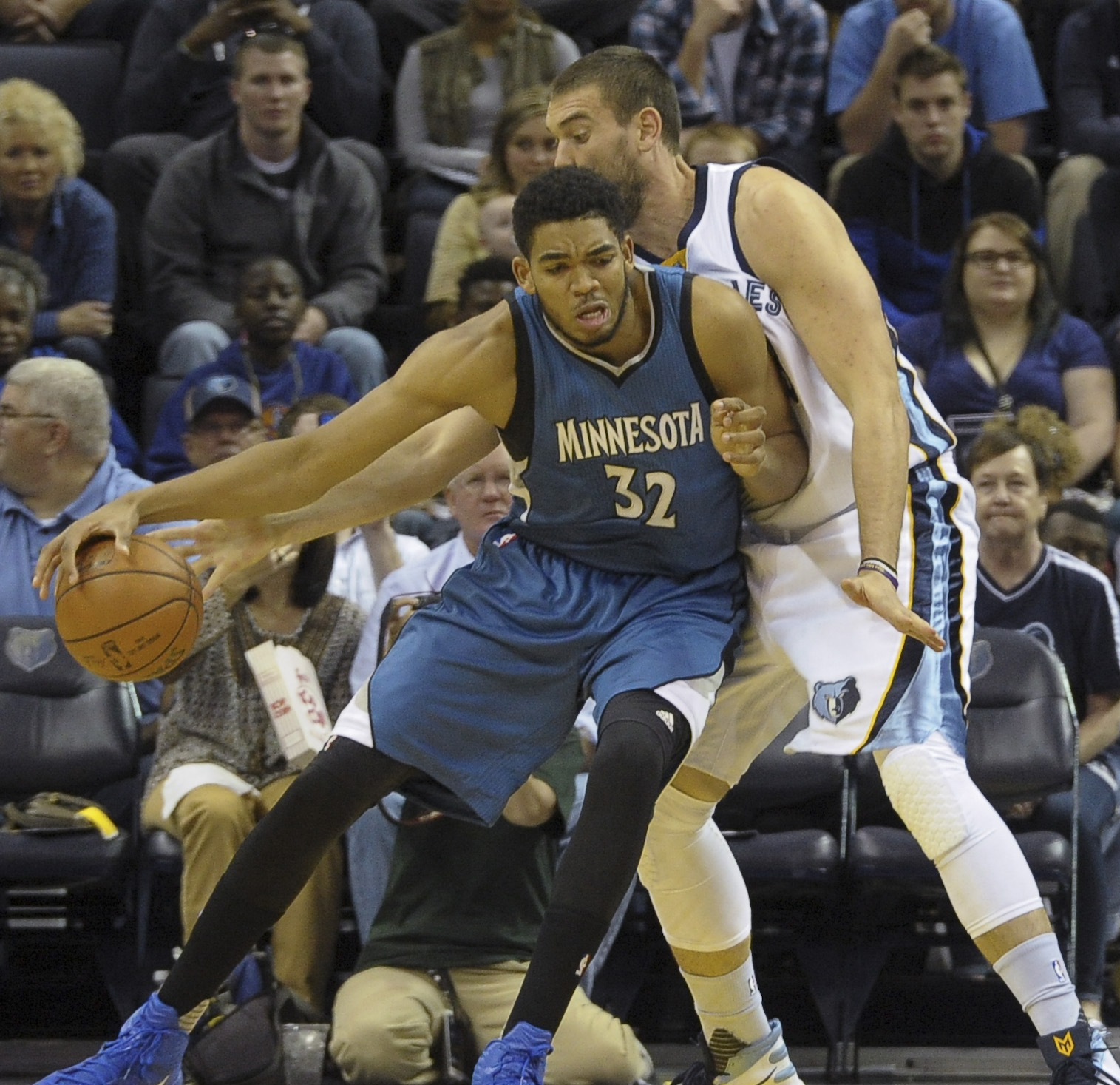 Oct 18, 2015; Memphis, TN, USA; Minnesota Timberwolves center Karl-Anthony Towns (32) handles the ball against Memphis Grizzlies center Marc Gasol (33) during the game at FedExForum. Mandatory Credit: Justin Ford-USA TODAY Sports
