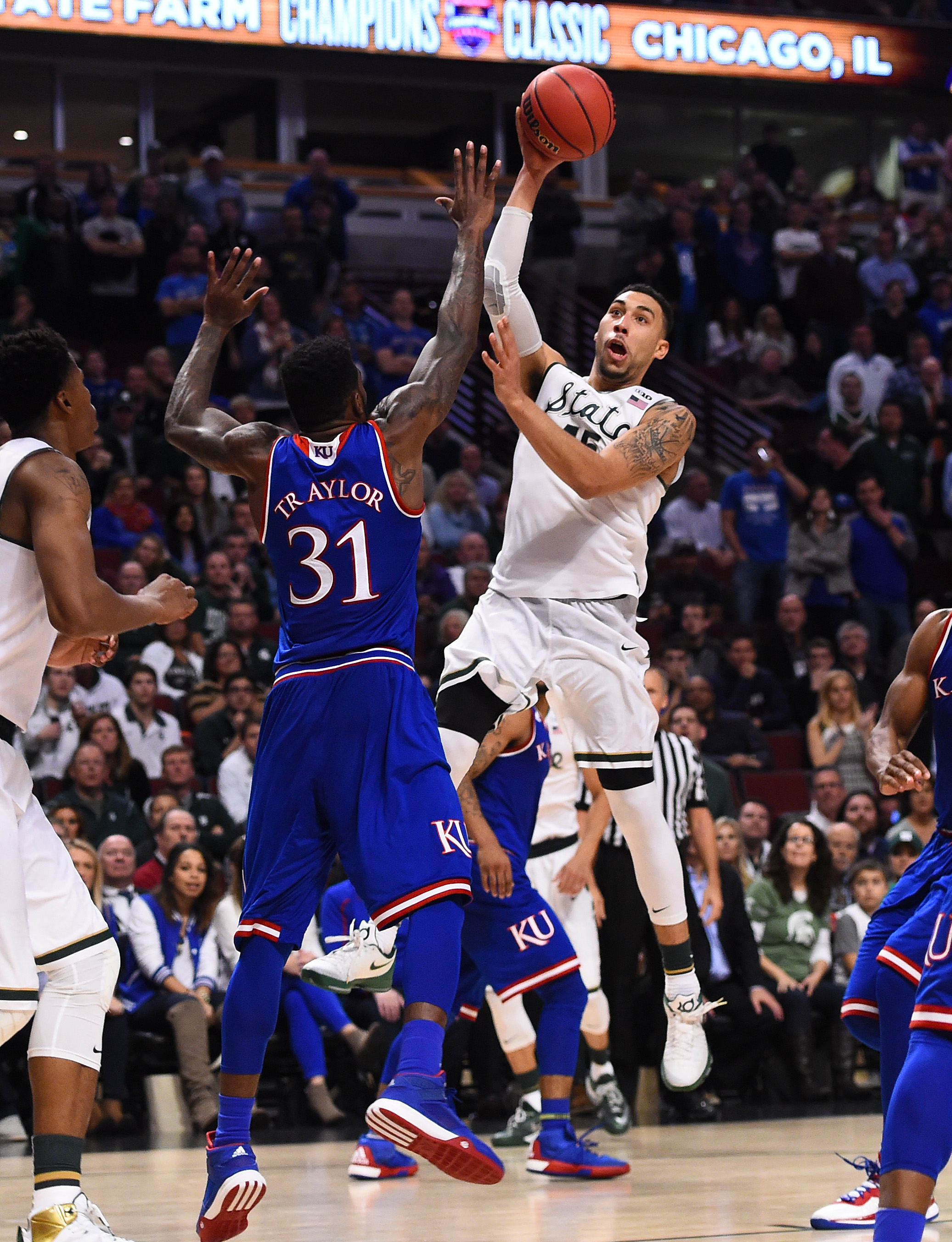 Nov 17, 2015; Chicago, IL, USA; Michigan State Spartans guard Denzel Valentine (45) shoots the ball against Kansas Jayhawks forward Jamari Traylor (31) during the first half at the United Center. Michigan State defeats Kansas 79-73. Mandatory Credit: Mike DiNovo-USA TODAY Sports